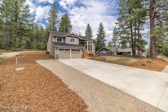 81 Parkland Dr, Blanchard, ID 83804 - view of front of property featuring concrete driveway, an attached garage, and central AC unit