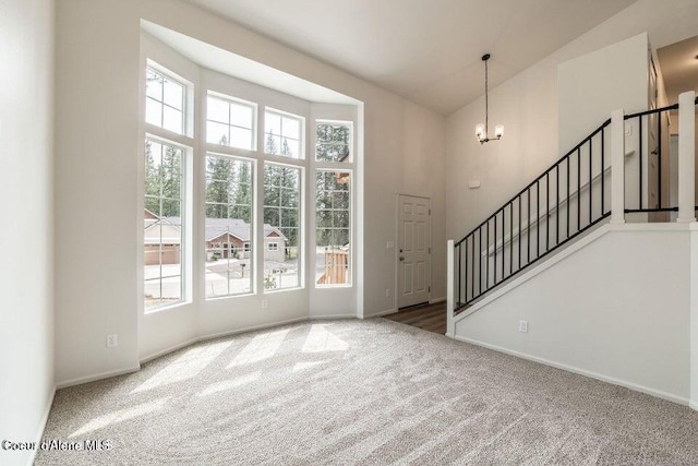 81 Parkland Dr, Blanchard, ID 83804 - carpeted entrance foyer featuring stairs, a high ceiling, a chandelier, and baseboards