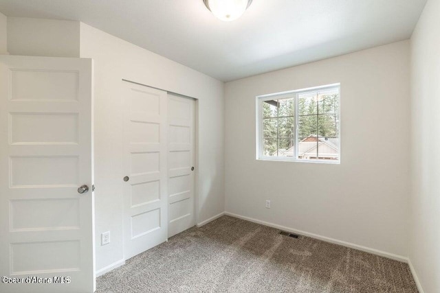 81 Parkland Dr, Blanchard, ID 83804 - unfurnished bedroom with carpet floors, a closet, and baseboards