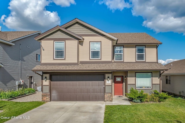 1749 N Minam Loop, Post Falls, ID 83854 - view of front facade featuring concrete driveway, a front lawn, an attached garage, and a shingled roof