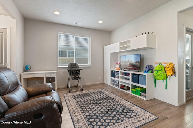 1749 N Minam Loop, Post Falls, ID 83854 - living area featuring wood finished floors, baseboards, and recessed lighting