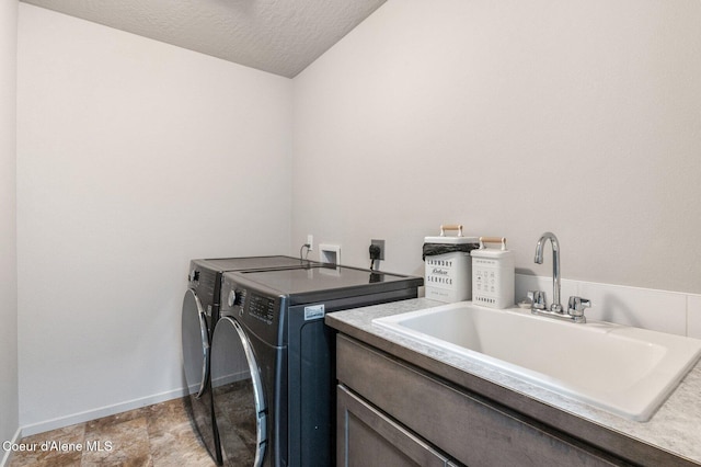 1749 N Minam Loop, Post Falls, ID 83854 - washroom with washing machine and dryer, cabinet space, baseboards, and a textured ceiling