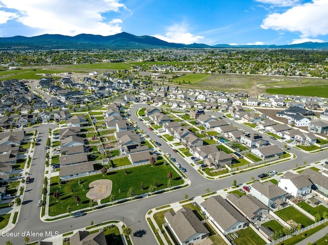 1749 N Minam Loop, Post Falls, ID 83854 - aerial view of property and surrounding area with a mountain backdrop and nearby suburban area
