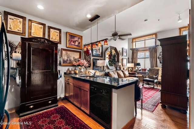 124 Village Ln Unit 108, Sandpoint, ID 83864 - kitchen featuring black dishwasher, dark countertops, ceiling fan, light wood finished floors, and recessed lighting