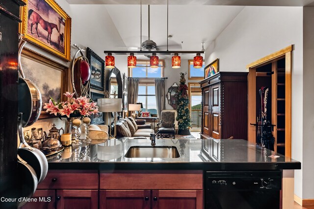 124 Village Ln Unit 108, Sandpoint, ID 83864 - kitchen with black dishwasher, reddish brown cabinets, open floor plan, a sink, and dark countertops