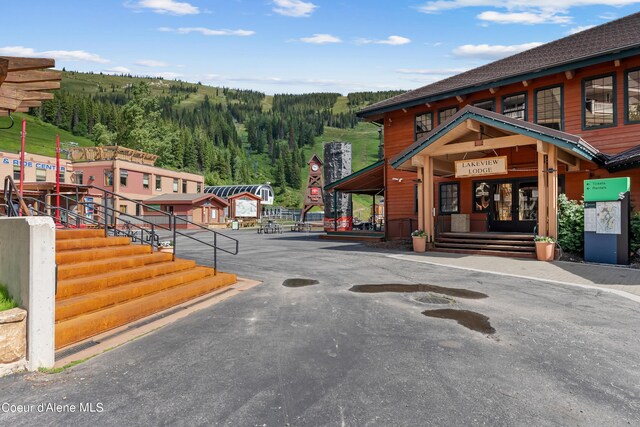 124 Village Ln Unit 108, Sandpoint, ID 83864 - view of asphalt road with a forest view