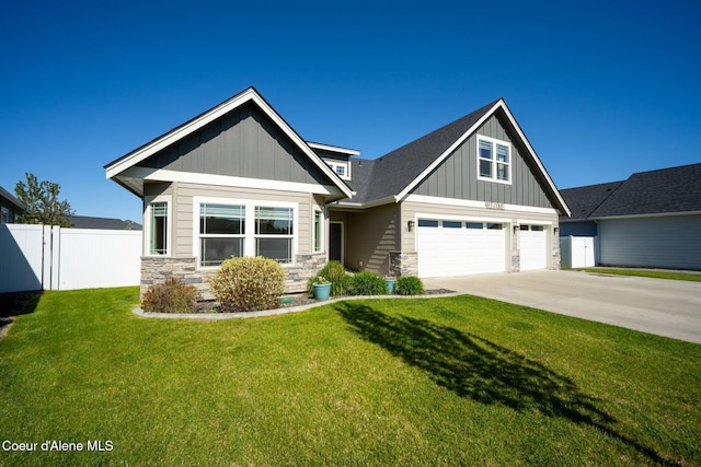 craftsman inspired home featuring concrete driveway, stone siding, board and batten siding, and a garage