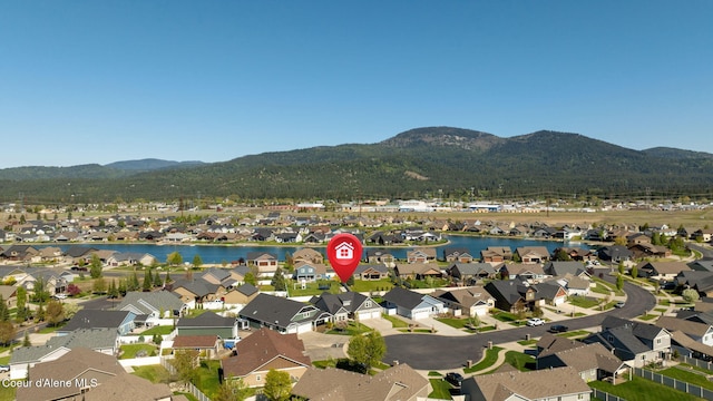 aerial overview of property's location featuring nearby suburban area and a water and mountain view