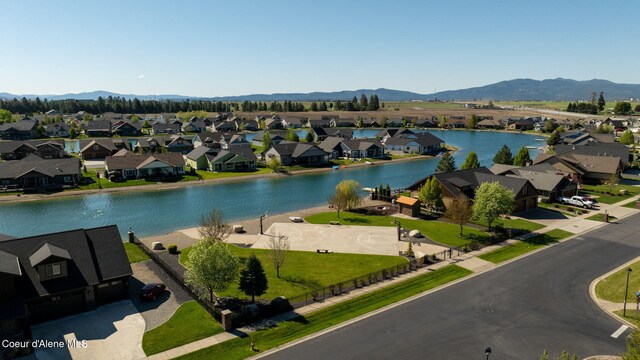 water view featuring nearby suburban area and a mountainous background