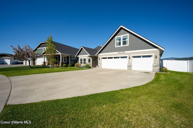 craftsman-style house with driveway, board and batten siding, and stone siding