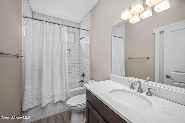full bath featuring shower / bath combo with shower curtain, toilet, wood finished floors, and vanity