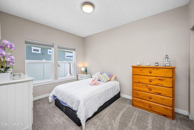 bedroom with baseboards and carpet floors