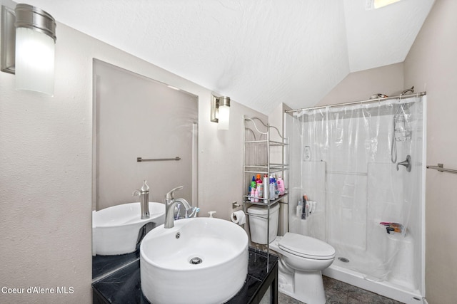 full bath featuring a stall shower, toilet, lofted ceiling, and a textured ceiling
