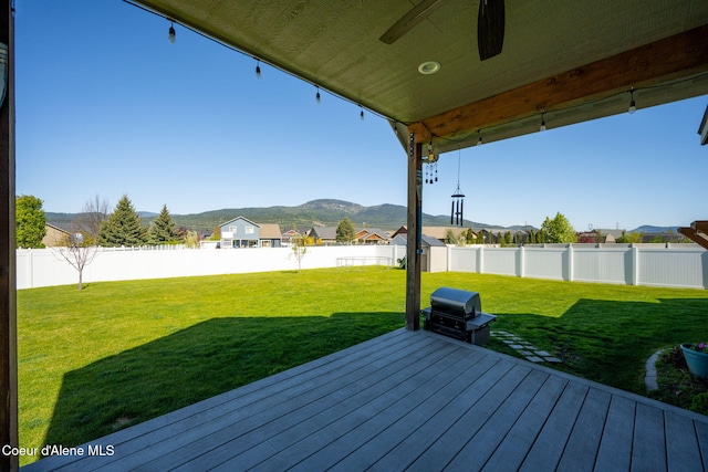 wooden terrace featuring a mountain view and ceiling fan