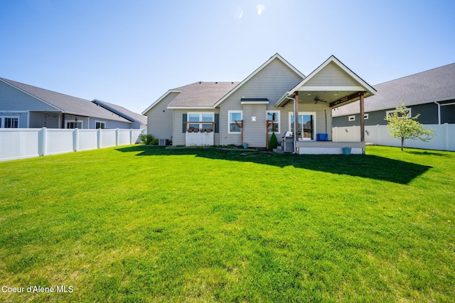 rear view of property featuring ceiling fan and a patio