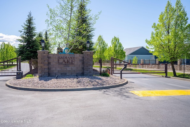 community sign with a gate and fence