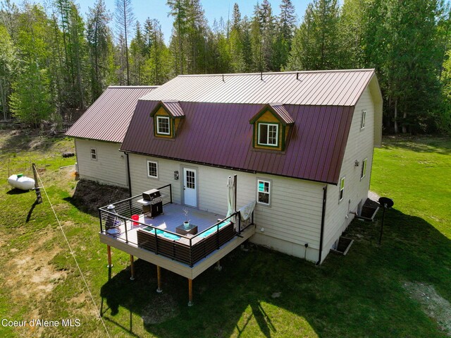346 Brookfield Rd, Sandpoint, ID 83864 - rear view of house with a wooden deck, a yard, and metal roof