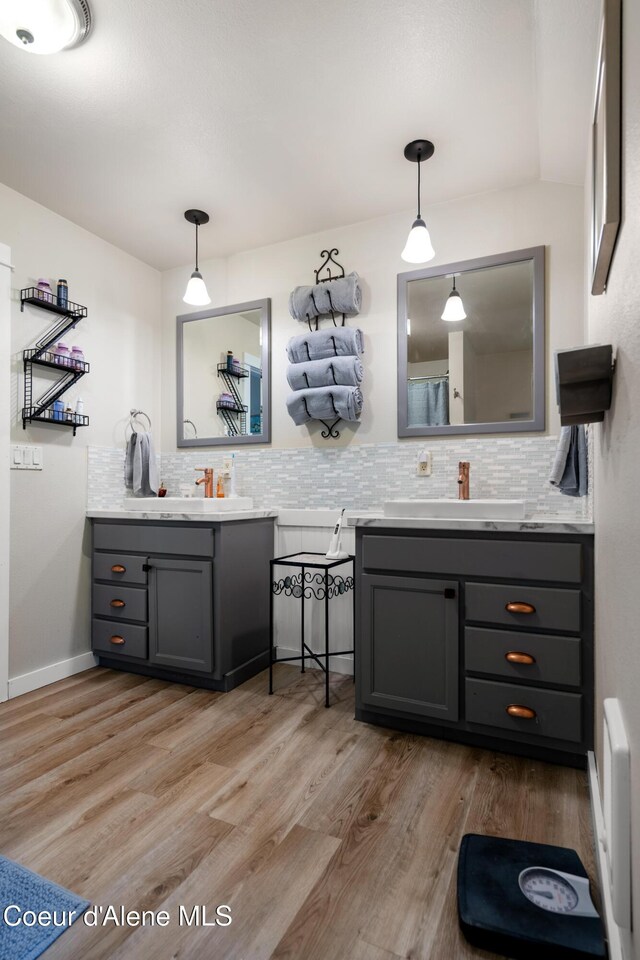 346 Brookfield Rd, Sandpoint, ID 83864 - bathroom featuring backsplash, two vanities, and wood finished floors