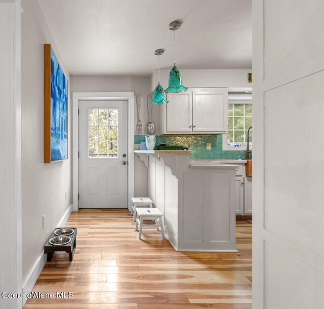 346 Brookfield Rd, Sandpoint, ID 83864 - doorway to outside with light wood finished floors, plenty of natural light, and baseboards