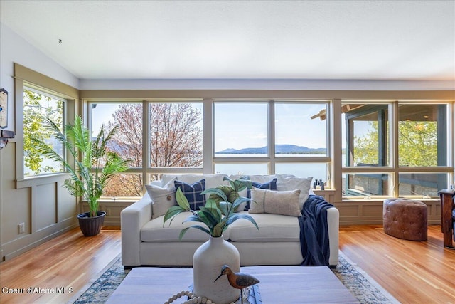 living area with wood finished floors and a water view