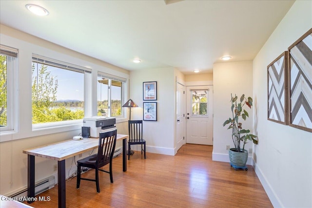 office space featuring wood finished floors, baseboards, a baseboard radiator, and recessed lighting
