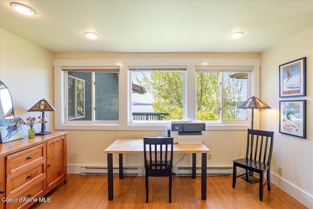 home office with a baseboard radiator, light wood-style flooring, and recessed lighting