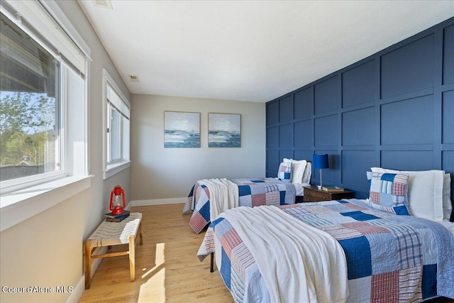 bedroom featuring baseboards and light wood-type flooring