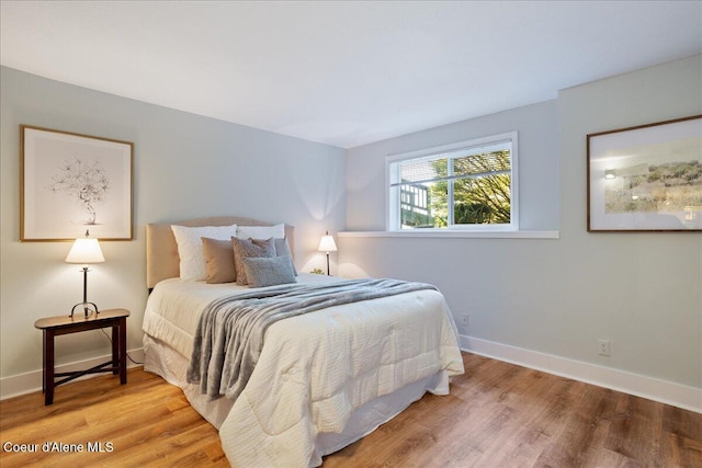 bedroom featuring baseboards and wood finished floors