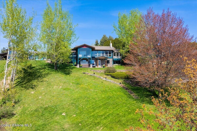 rear view of property featuring a yard