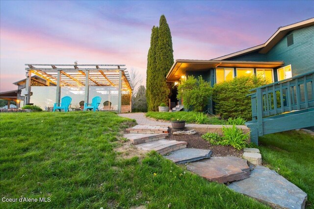yard at dusk with a yard and a pergola