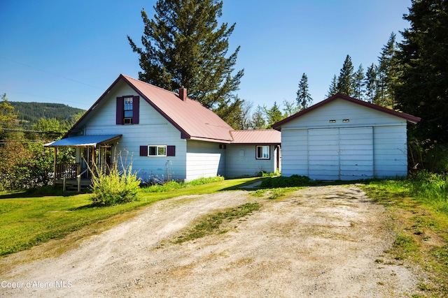50 Smokehouse Rd, Sagle, ID 83860 - view of front of home with driveway, metal roof, and a chimney