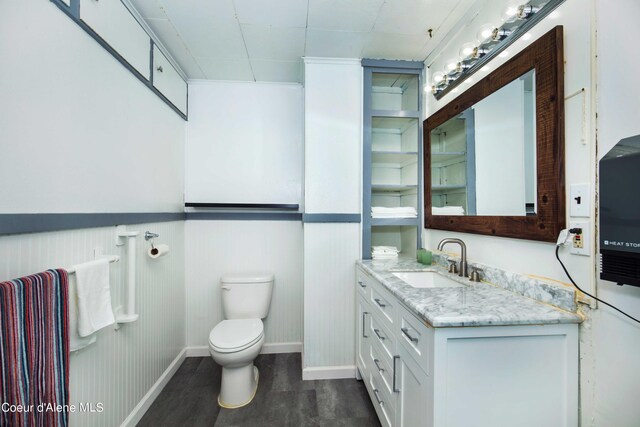 50 Smokehouse Rd, Sagle, ID 83860 - bathroom with toilet, vanity, wood finished floors, and baseboards