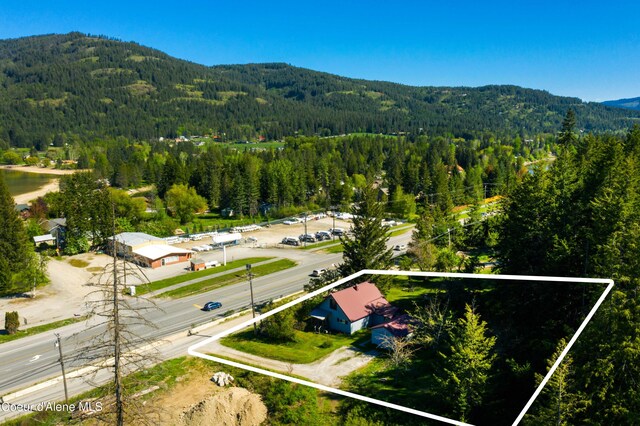 50 Smokehouse Rd, Sagle, ID 83860 - aerial overview of property's location with a heavily wooded area, a mountain backdrop, and property parcel outlined