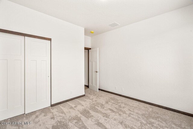 1451 W Tali Ave, Post Falls, ID 83854 - unfurnished bedroom featuring carpet flooring and a closet