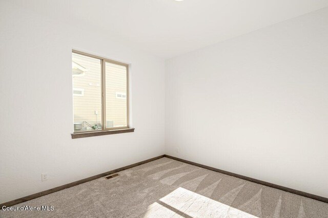 1451 W Tali Ave, Post Falls, ID 83854 - carpeted empty room featuring baseboards