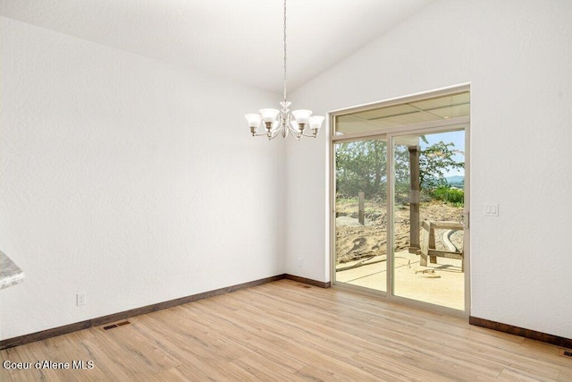 1451 W Tali Ave, Post Falls, ID 83854 - unfurnished dining area with vaulted ceiling, light wood-style floors, and a chandelier