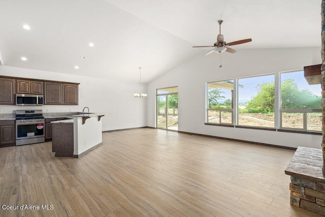 1451 W Tali Ave, Post Falls, ID 83854 - kitchen with stainless steel appliances, open floor plan, a ceiling fan, recessed lighting, and high vaulted ceiling