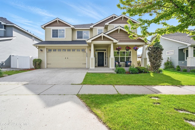 1823 N Clark Fork Pkwy, Post Falls, ID 83854 - craftsman house with concrete driveway, a garage, a porch, and a shingled roof