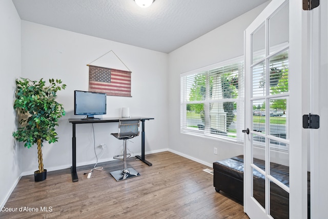 1823 N Clark Fork Pkwy, Post Falls, ID 83854 - office area featuring wood finished floors, baseboards, and a textured ceiling