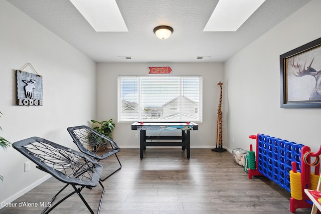 1823 N Clark Fork Pkwy, Post Falls, ID 83854 - game room featuring a skylight, wood finished floors, and baseboards