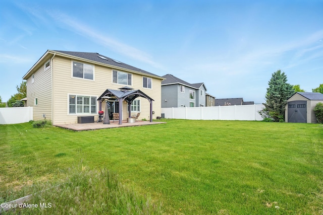 1823 N Clark Fork Pkwy, Post Falls, ID 83854 - rear view of property featuring a gazebo, a storage shed, an outbuilding, a patio area, and central AC unit