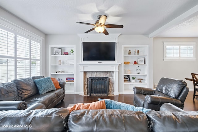 1823 N Clark Fork Pkwy, Post Falls, ID 83854 - living area featuring a ceiling fan, a fireplace, built in features, and dark wood-type flooring