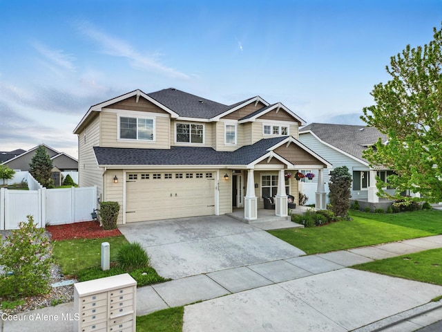 1823 N Clark Fork Pkwy, Post Falls, ID 83854 - view of front of property with an attached garage, a porch, concrete driveway, and a shingled roof