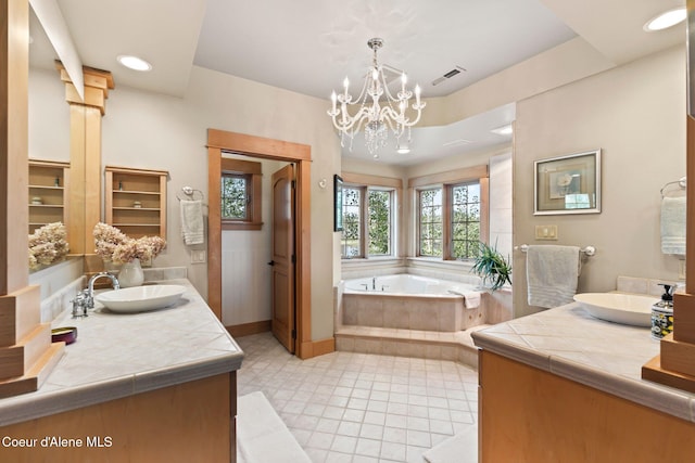 679 Comeback Bay Ln, Sagle, ID 83860 - bathroom featuring two vanities, a bath, baseboards, a chandelier, and recessed lighting