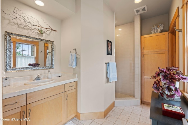 679 Comeback Bay Ln, Sagle, ID 83860 - bathroom with tile patterned flooring, vanity, walk in shower, baseboards, and recessed lighting