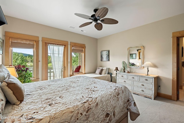 679 Comeback Bay Ln, Sagle, ID 83860 - bedroom with access to exterior, multiple windows, light colored carpet, and a ceiling fan