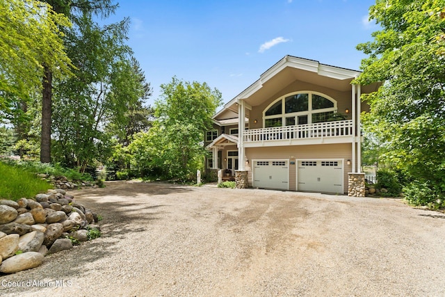 679 Comeback Bay Ln, Sagle, ID 83860 - view of front facade featuring dirt driveway, a balcony, and a garage