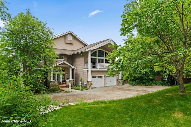 679 Comeback Bay Ln, Sagle, ID 83860 - view of front of home featuring driveway, an attached garage, covered porch, a balcony, and a front lawn