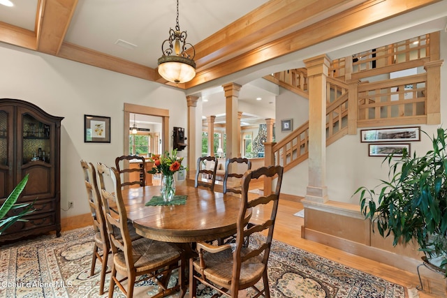 679 Comeback Bay Ln, Sagle, ID 83860 - dining room featuring decorative columns, baseboards, light wood-style flooring, recessed lighting, and stairs