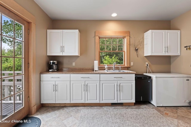 679 Comeback Bay Ln, Sagle, ID 83860 - washroom featuring cabinet space, light stone finish floors, and recessed lighting